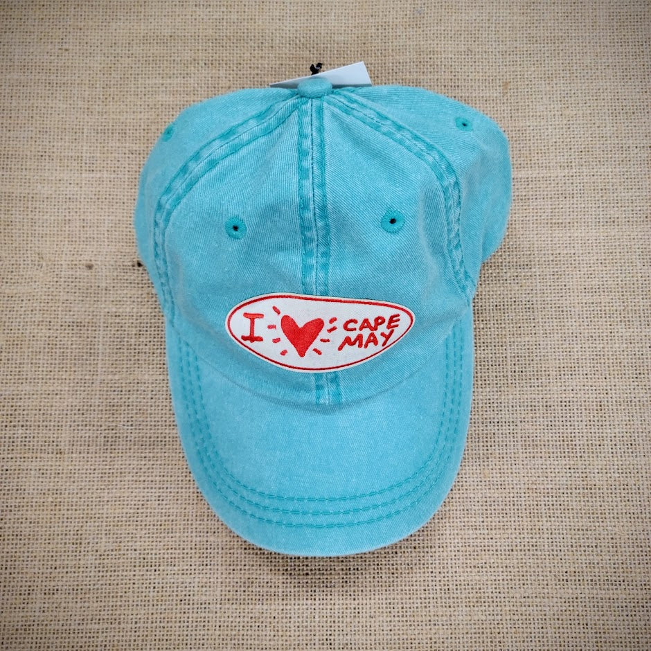 A blue hat with an oval patch that says, "I Heart Cape May"
