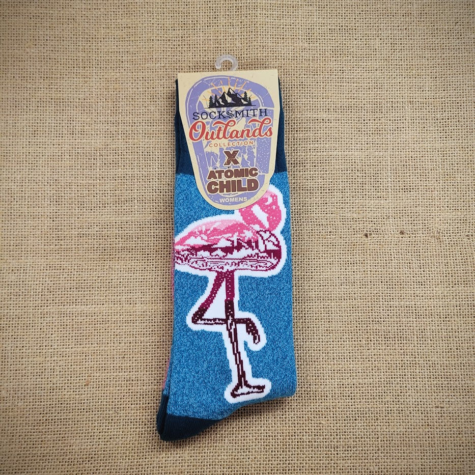 A pair of blue socks with pink flamingos on them.