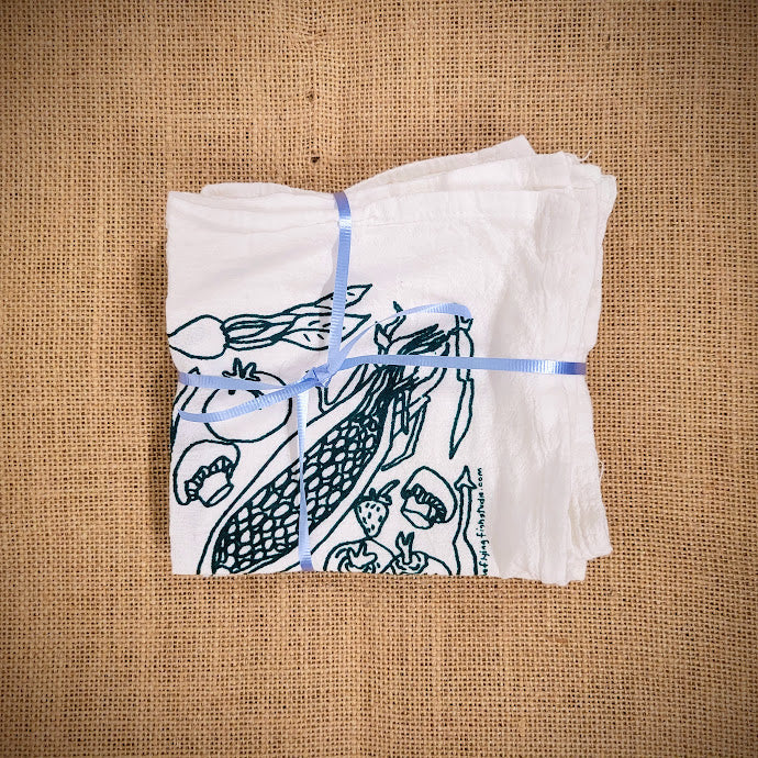 Napkin set of the 'Veggies' design in green ink.