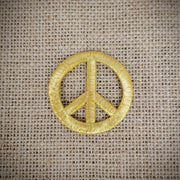 Patch of a gold peace sign.