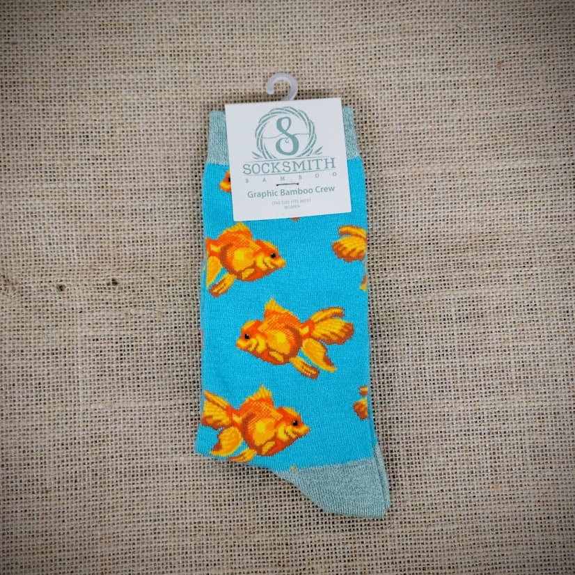 An aqua blue pair of socks with goldfish on them.