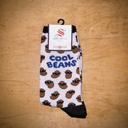 A pair of ivory socks with a "cool beans" design.