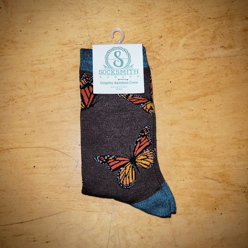 A pair of brown socks with butterflies on them.