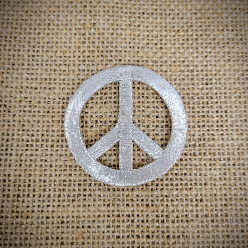 Patch of a silver peace sign.