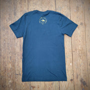 The back of a dark blue, short-sleeved T-shirt with the 'Flying Fish Studio' logo in yellow, screen-printed on the back of the neck. The words 'West Cape May, NJ' sit beneath it.