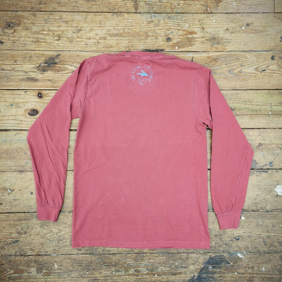 The back of a long-sleeve, brick-red t-shirt featuring the "Flying Fish Studio" logo on the back neck.