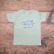 A light green t-shirt featuring a happy shark on the front in navy ink.