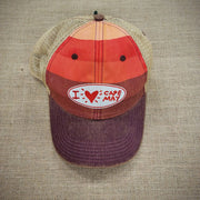 A multi-striped trucker hat with an oval patch that says, "I Heart Cape May"