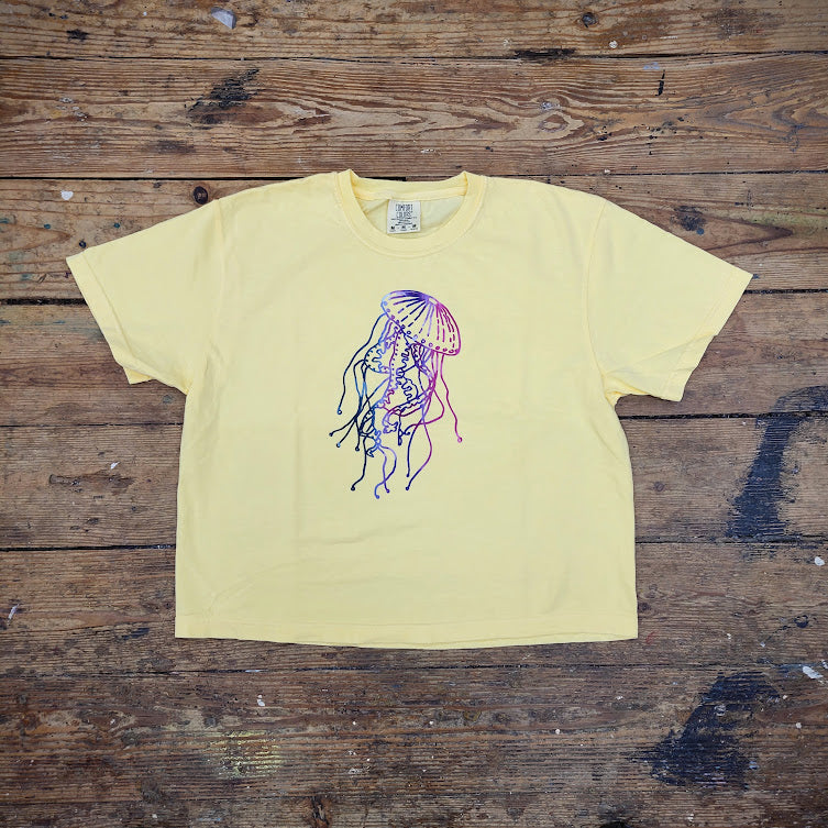Cropped. buttery-yellow t-shirt with a jellyfish on the front.