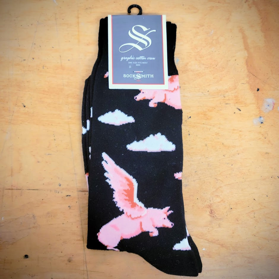 A black pair of socks with clouds and flying pigs on them.