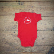 A red baby onesie depicting the Flying Fish Studio logo on the back neck.
