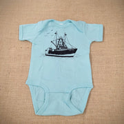 An aqua baby onesie with a graphic of a scallop boat.