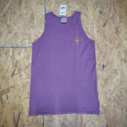 Purple tank top with the 'Flying Fish Studio' logo on the left chest in orange ink laid flat on a wooden background. 