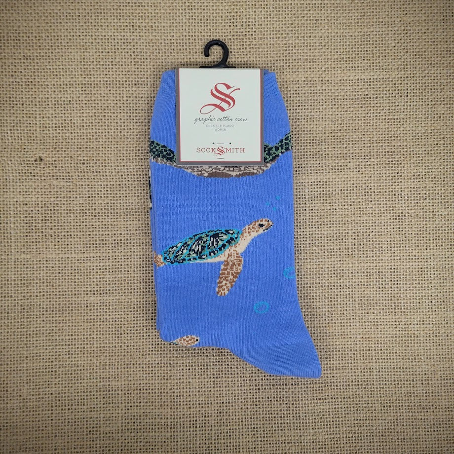 A pair of blue socks with sea turtles on them.