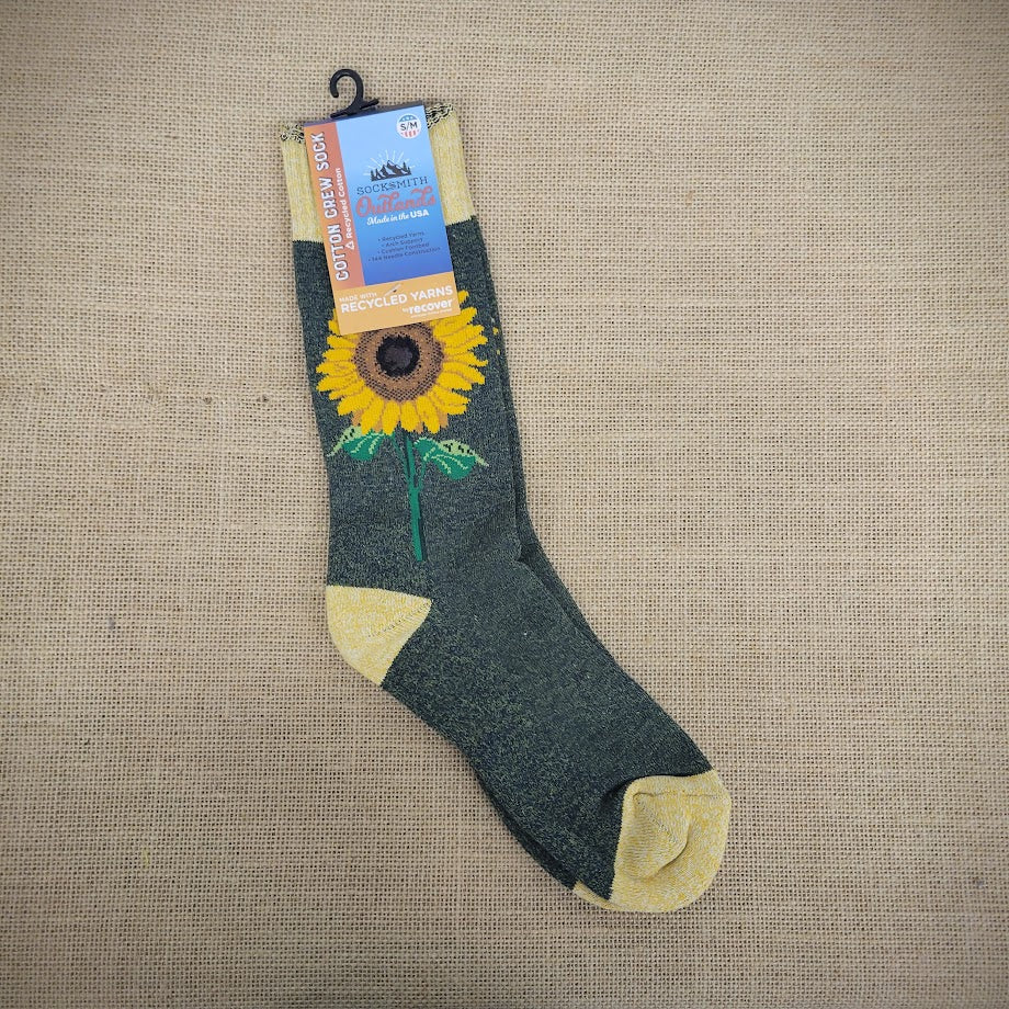 A pair of crew socks with a sunflower design on the front. 