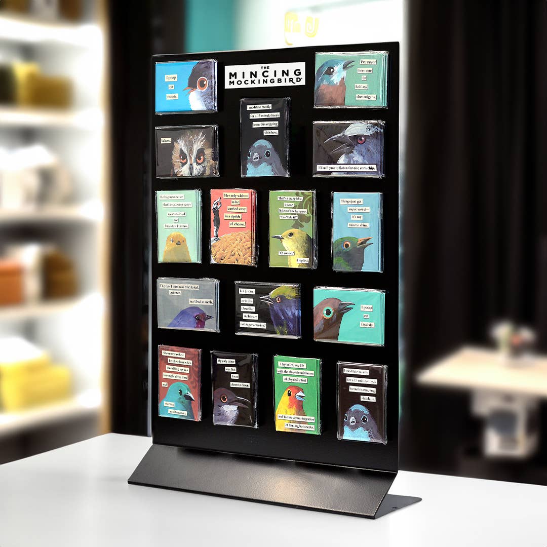 Display stand with various bird-themed boxes on a blurred indoor background