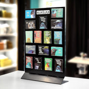 Display stand with various bird-themed boxes on a blurred indoor background.