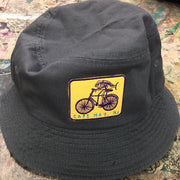 A solid black bucket hat with a 'Fish on a Bike' patch on front.