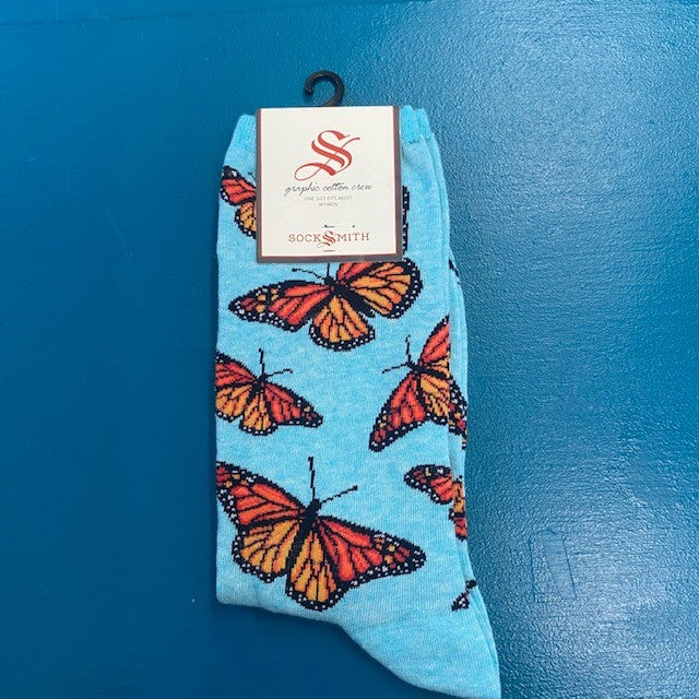A pair of blue socks with butterflies on them.