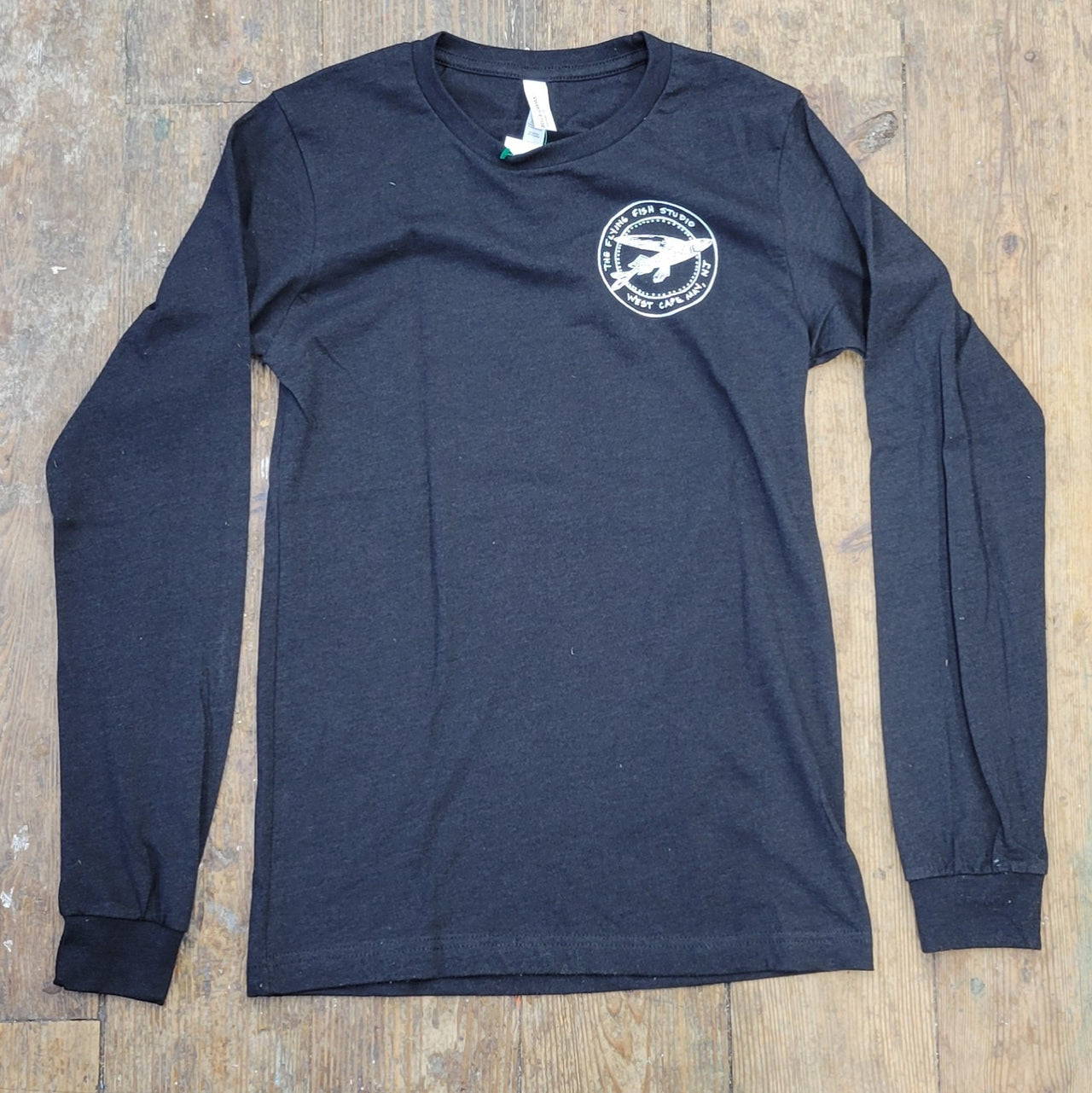 Heather, black long-sleeve with the 'Flying Fish' logo on the left chest in white ink.