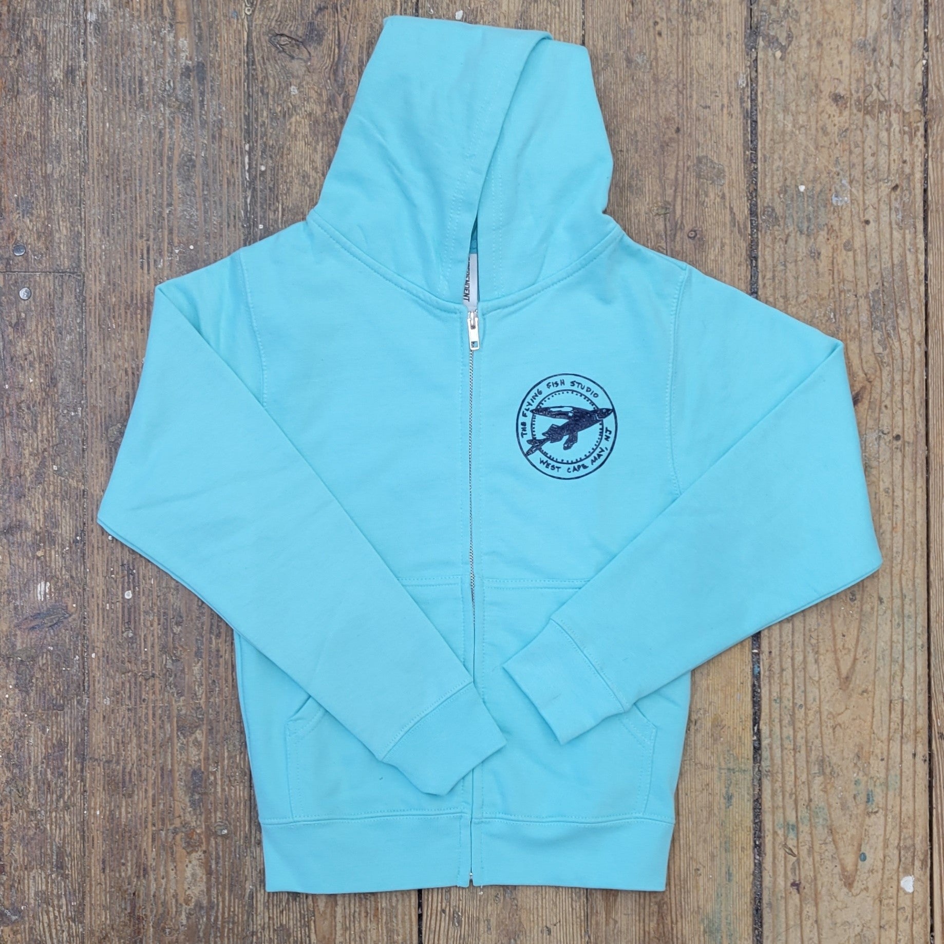 Aqua Blue zip-up jacket featuring the 'Flying Fish' logo on the left chest in navy ink.
