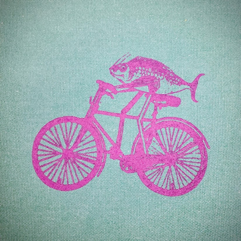Close-up of the purple fish on a bike.