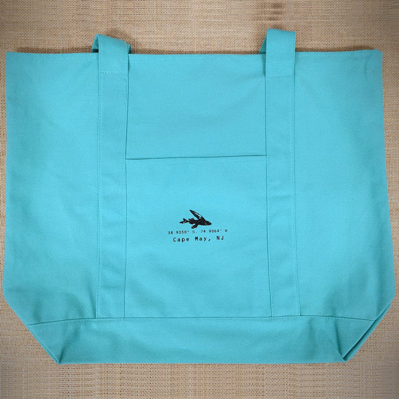 A blue tote bag with the 'Flying Fish' coordinates on it.