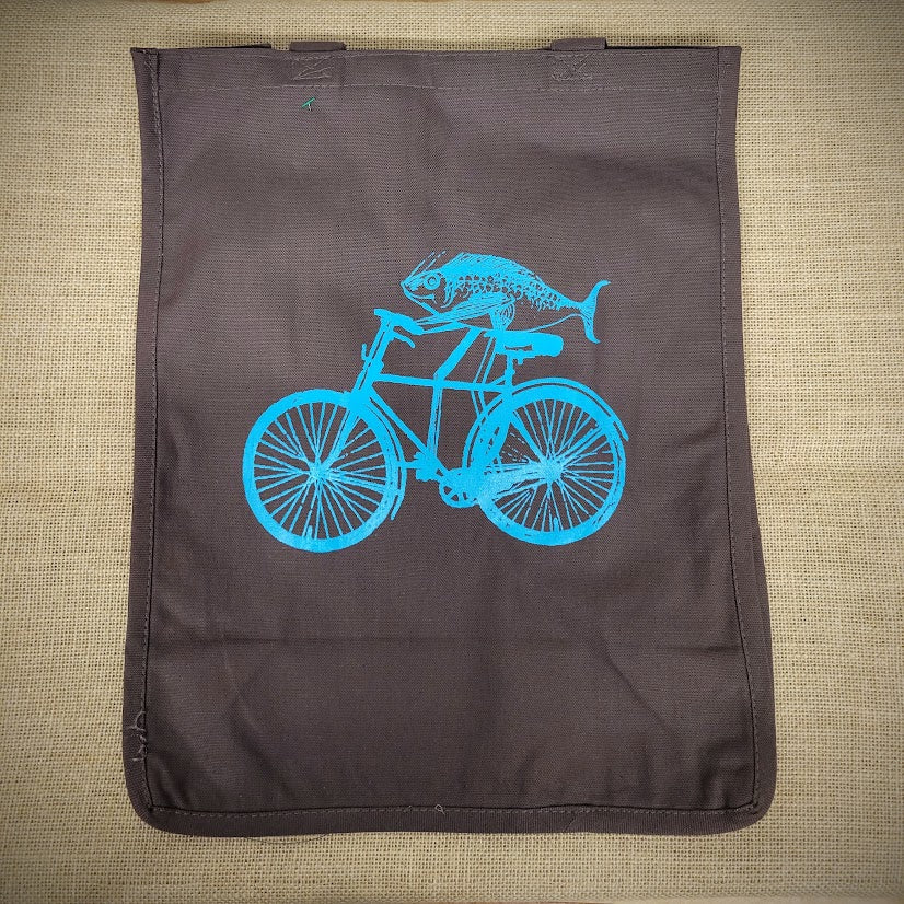 Brown grocery tote with a blue fish on a bike on it.