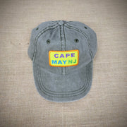 A green hat with a 'West Cape May' patch on it.