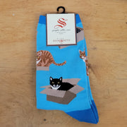 A blue pair of socks with cats in boxes on them.
