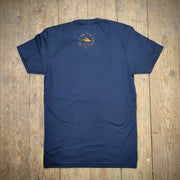 A blue t-shirt with the 'Flying Fish' logo on the back neck in orange ink.