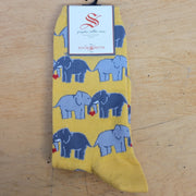 A pair of yellow socks with elephants on them.
