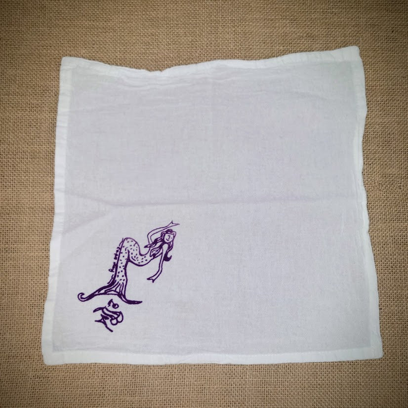 Flour sack napkin featuring the 'Mermaid' design at the bottom left in purple ink.