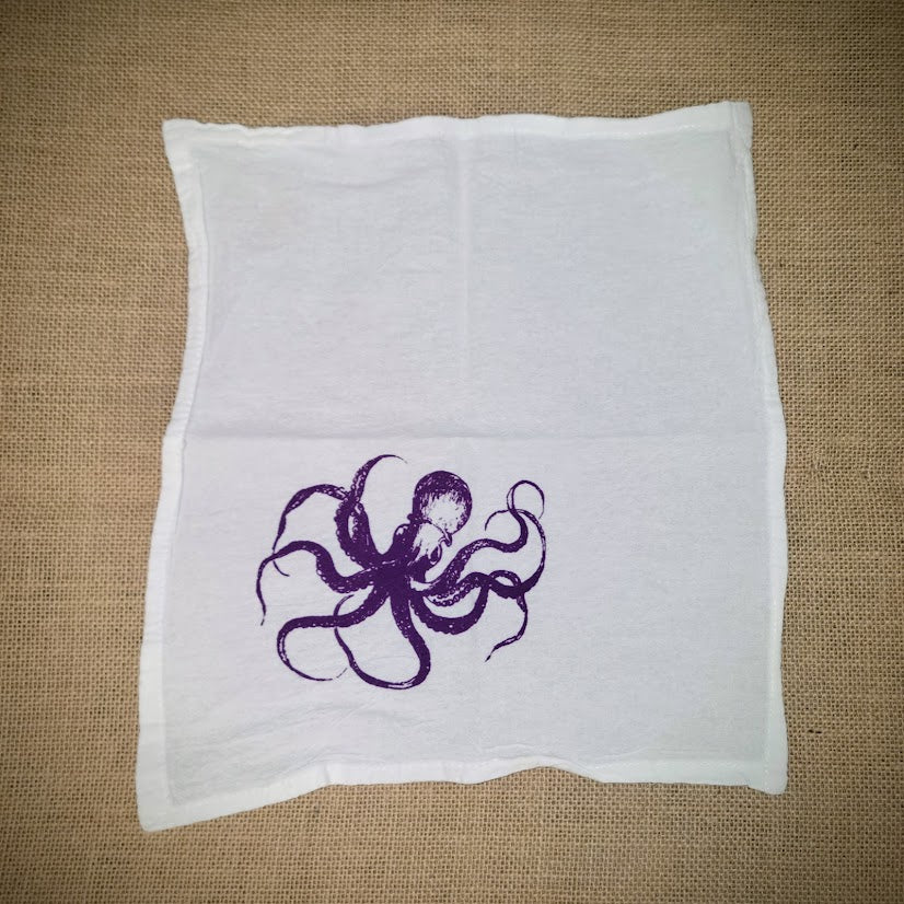 Flour sack napkin featuring the purple 'Octopus' design on the bottom left.