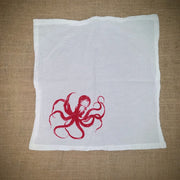 Flour sack napkin featuring the red 'Octopus' design on the bottom left.