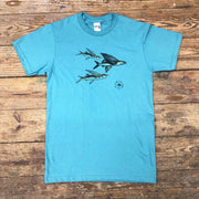 A blue t-shirt featuring three flying fish on the front.