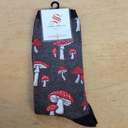 A pair of brown socks with fungi on them.
