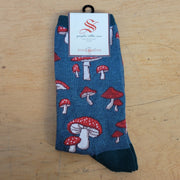 A pair of green socks with fungi on them.
