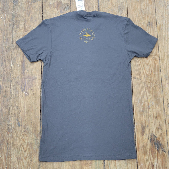 A brownish-grey t-shirt with the 'Flying Fish Studio' design on the back neck in gold ink.
