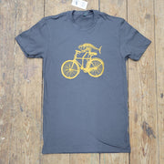 A brownish-grey t-shirt with the 'Fish on a Bike' design on the front in gold ink.