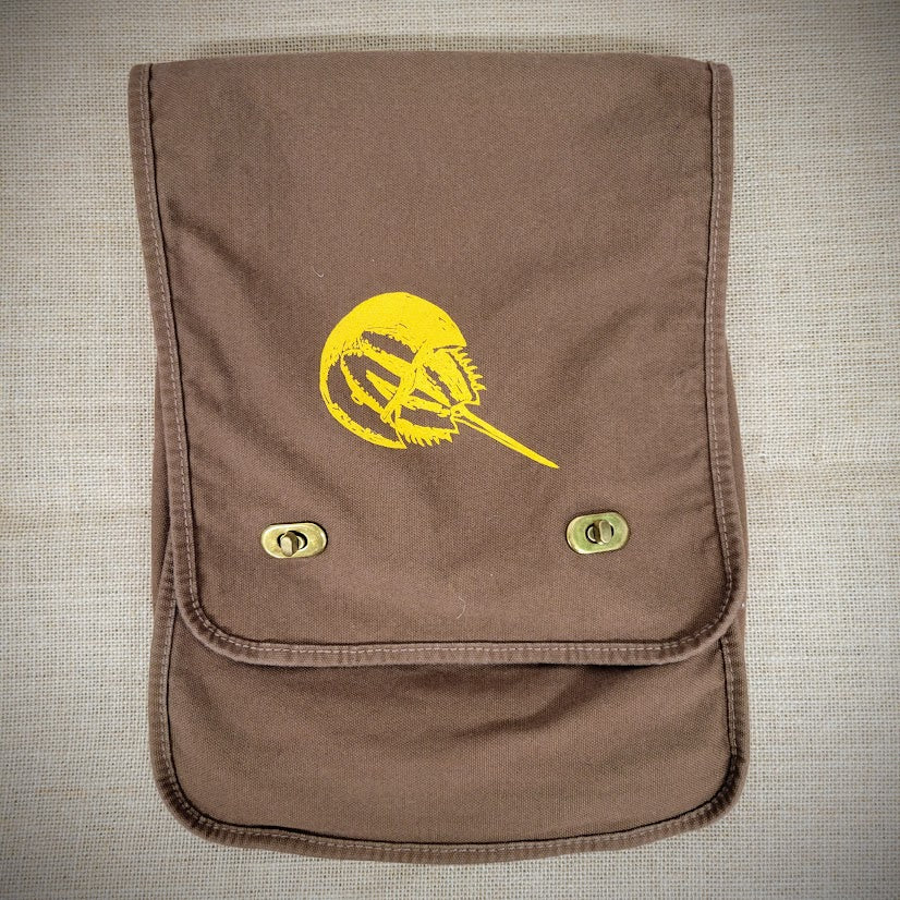 Brown, canvas bag with a yellow horseshoe crab design on the front.