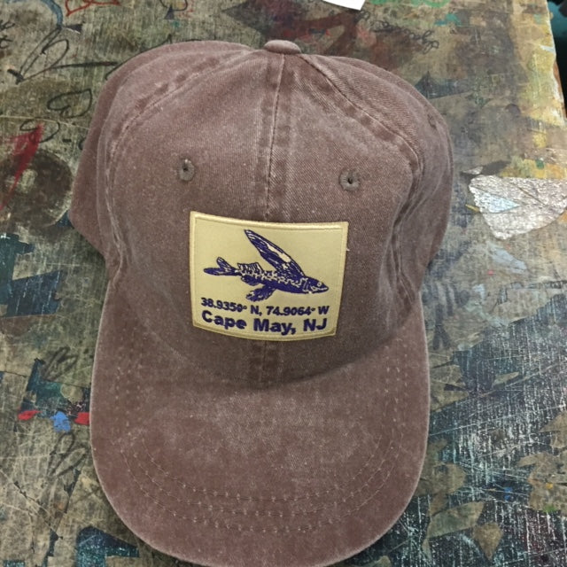 Classic, brown dad hat with a 'Flying Fish Coordinates' patch ironed onto the front.