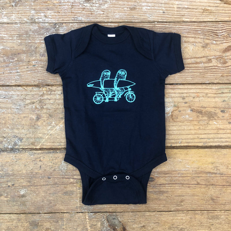 Navy blue onesie featuring a 'Sloths on a Tandem' design on the front in light blue ink.