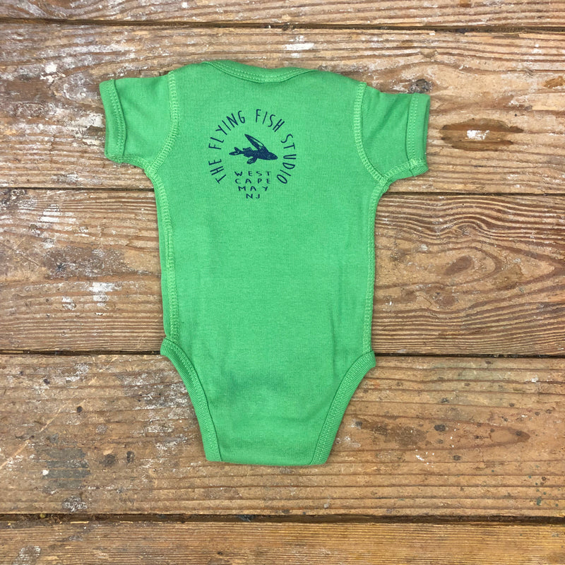 Light green onesie back featuring the 'Flying Fish' logo on the upper back in navy ink.