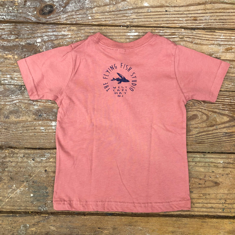 A mauve t-shirt featuring the 'Flying Fish Studio' logo on the back neck in navy ink.