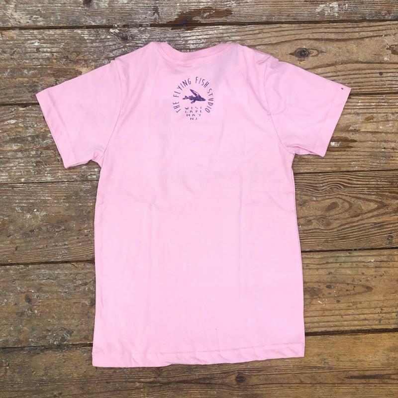 A pink t-shirt featuring the 'Flying Fish Studio' on the back neck in purple ink.