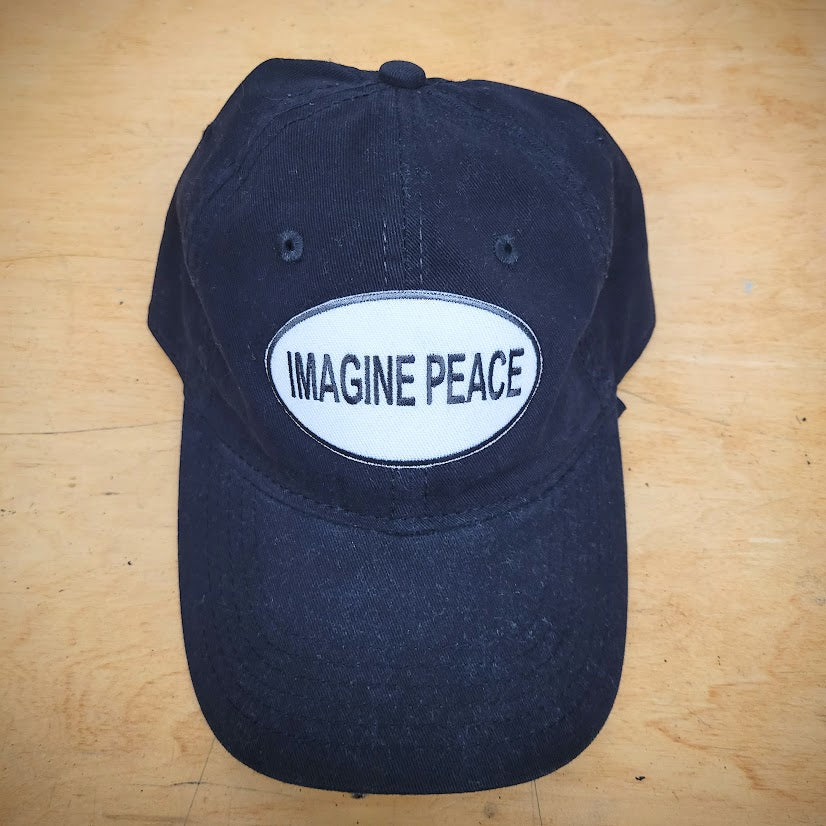 A solid black t-shirt with an 'Imagine Peace' patch on the front.