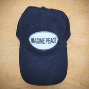 A solid black t-shirt with an 'Imagine Peace' patch on the front.