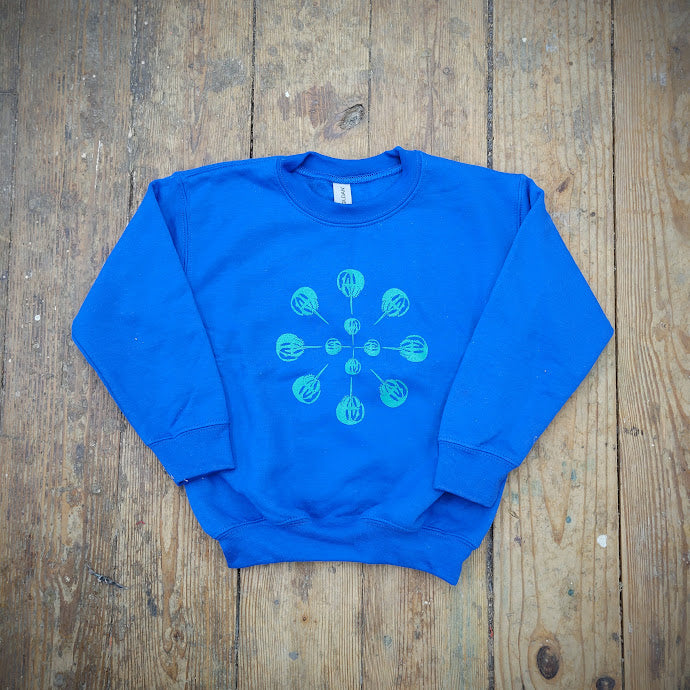 A royal blue sweatshirt with a 'Horseshoe Crab' mandala screen-printed on the front with blue ink.