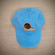 A blue hat with a 'horseshoe crab' patch on the front.